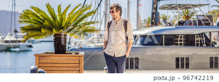 BANNER, LONG FORMAT Man tourist on background of Yacht marina, beautiful Mediterranean landscape in warm colors. Montenegro, Kotor Bay, Tivat city. Porto Montenegro marina view. Go Everywhere. Travel BANNER, LONG FORMAT Man tourist on background of Yacht marina, beautiful Mediterranean landscape in warm colors. Montenegro, Kotor Bay, Tivat city. Porto Montenegro marina view. Go Everywhere. Travel 96742219