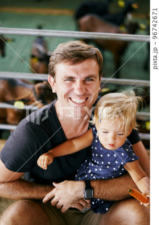 Smiling dad near paddock with little girl on lap. High quality photo Smiling dad near paddock with little girl on lap. High quality photo 96742671