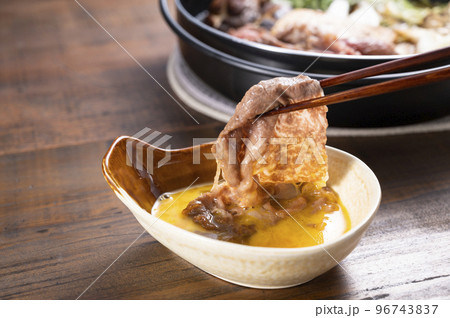 すき焼きの肉を卵につける すき焼きの肉を卵につける 96743837