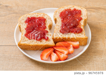 whole wheat bread with strawberry jam and fresh strawberry 96745978