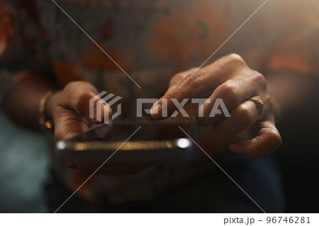 Close-up of woman's hand using a smartphone during coffee break. Close-up of woman's hand using a smartphone during coffee break. 96746281