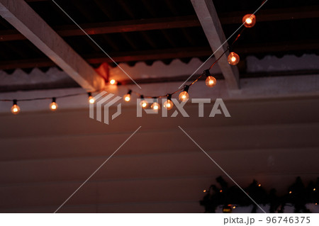 A retro garland of incandescent lamps 96746375