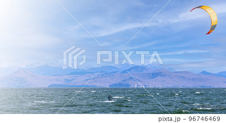 Kitesurfing on the waves in the Pacific Ocean off the coast of the Kamchatka Peninsula 96746469