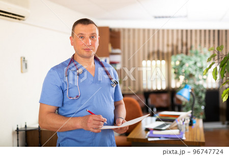 Portrait of man doctor standing at office 96747724