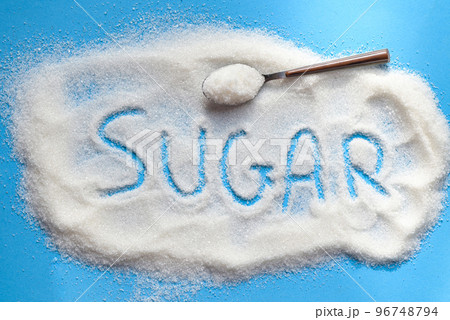 Sugar on spoon and blue background, white sugar for food and sweets dessert candy heap of sweet sugar crystalline granulated 96748794