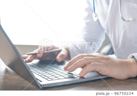 Medical technology concept. Doctor works with laptop. remote health care service. Digital laptop at hospital. doctor typing on laptop computer in medical office 96750224