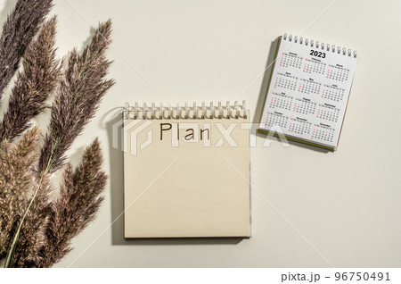 2023 time for new start. Plan word and calendar 2023 on white table background. New Year plans for 2023, space for your text on notepad, calendar on desk. Business annual plan and development 2023 time for new start. Plan word and calendar 2023 on white table background. New Year plans for 2023, space for your text on notepad, calendar on desk. Business annual plan and development 96750491