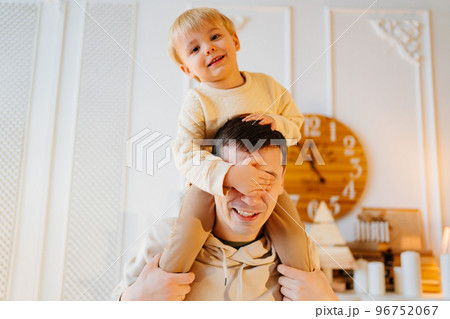dad rolls his son on his shoulders. father-child games.  96752067