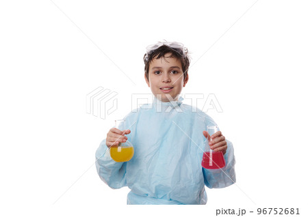 Adorable smart teenager schoolboy wearing lab coat, holding two laboratory glass flask with reagents and chemicals, conducting scientific experiments at chemistry class, isolated on white background Adorable smart teenager schoolboy wearing lab coat, holding two laboratory glass flask with reagents and chemicals, conducting scientific experiments at chemistry class, isolated on white background 96752681