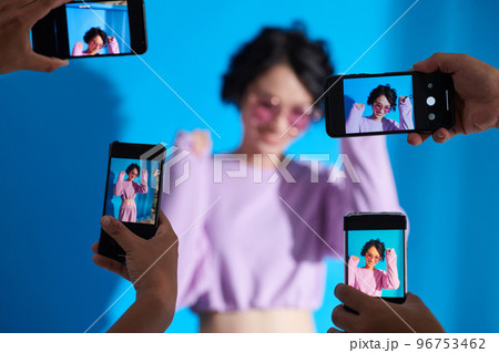 Dancing teenage influencer being photographed by subscribers 96753462