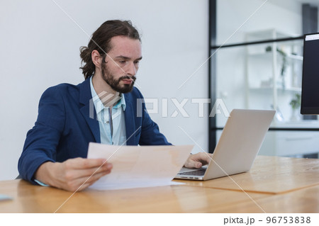 attractive businessperson sitting working in workplace. attractive businessperson sitting working in workplace. 96753838