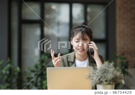Young asian businesswoman working at office using mobile phone.. 96754429