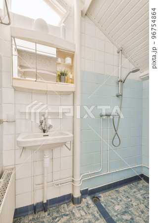 Interior of contemporary bathroom with shower and sink in minimal style in flat 96754864