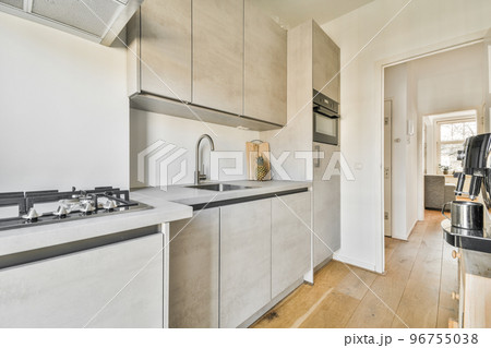 Light small home kitchen with wide window furnished with cupboards and shelves with appliances in modern urban apartment Light small home kitchen with wide window furnished with cupboards and shelves with appliances in modern urban apartment 96755038