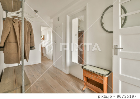 Comfortable couch located near carpet and table against window in spacious minimalist style living room in modern apartment 96755197