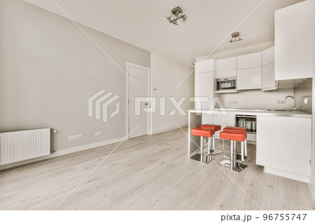 Interior of empty white kitchen with windows and wooden parquet floor 96755747