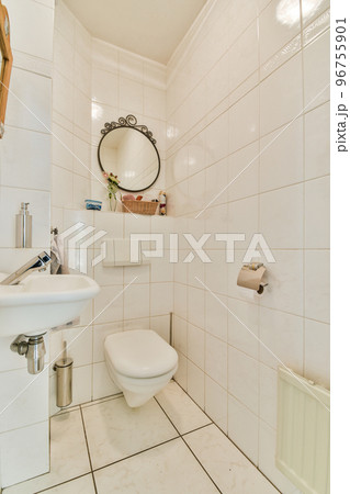 Modern toilet installed on wall under button in light restroom at home 96755901