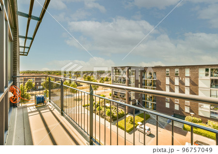 Sitting area in balcony with comfortable furniture around beautiful view Sitting area in balcony with comfortable furniture around beautiful view 96757049