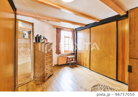 Interior of empty white room with windows with curtains and wooden parquet floor Interior of empty white room with windows with curtains and wooden parquet floor 96757050