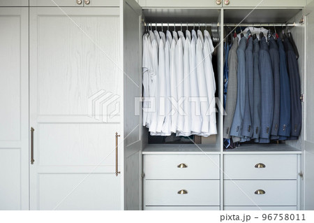 Male wardrobe furniture for business clothing neatly storage organization. Man closet with garment Male wardrobe furniture for business clothing neatly storage organization. Man closet with garment 96758011