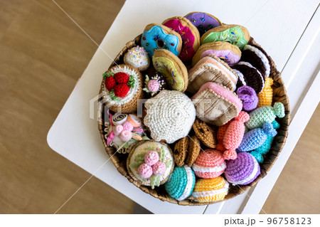 Toy food knitted from yarn. Sweets, pastries, cookies and cakes. Toy food knitted from yarn. Sweets, pastries, cookies and cakes. 96758123