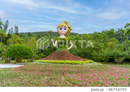 The fairy is holding a fairy wand and her green dress and red skirt are plants. The fairy is holding a fairy wand and her green dress and red skirt are plants. 96758705