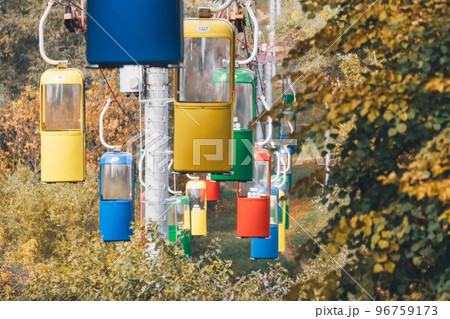 Colorful cableway cabins in autumn city park 96759173