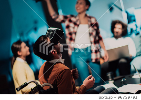 Business persons with a disability at work in modern open space coworking office on team meeting using virtual reality goggles. 96759793
