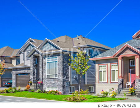 Suburban family house with green lawn in front 96764229