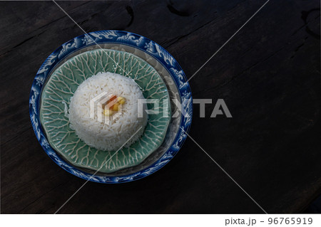 Jasmine rice topping with Corn kernels, Carrot sliced, Taro sliced on green bowl ceramic. Jasmine rice topping with Corn kernels, Carrot sliced, Taro sliced on green bowl ceramic. 96765919