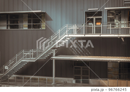White metal staircase in front of the modern office building. White metal staircase in front of the modern office building. 96766245