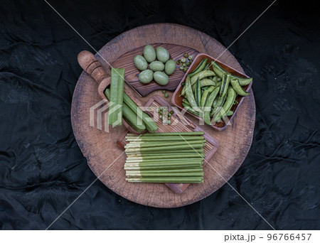 Composition of green snacks in assortment with different tastes and different shapes with Roasted sugar snap peas, Matcha cream covered biscuit sticks, Matcha latte crepe cookie and Matcha coated Composition of green snacks in assortment with different tastes and different shapes with Roasted sugar snap peas, Matcha cream covered biscuit sticks, Matcha latte crepe cookie and Matcha coated 96766457