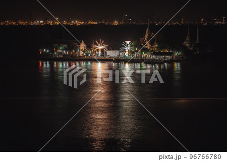 Riverside thai local temple is decorated with different color fireworks in the full moon festval. 96766780