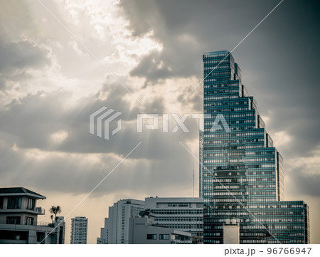 Architectural exterior view of modern high-rise building against the background of the sky with clouds. 96766947