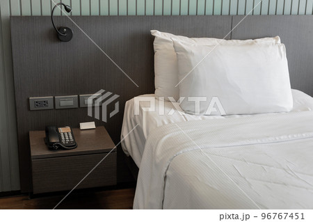 Modern bedroom interior with white pillow and bedside table 96767451