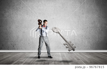 Breaking through access concept with man in room crashing concrete key 96767815