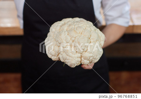 cauliflower holding in female hands close-up, man without face. 96768851