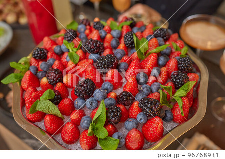 Sweet fruit and berry salad on white plate, marble baground, top view. Sweet fruit and berry salad on white plate, marble baground, top view. 96768931