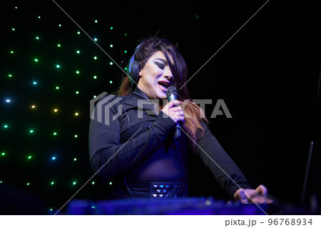 Portrait of young transgender woman in bright costume on color background. Portrait of young transgender woman in bright costume on color background. 96768934
