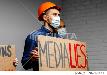 Media lies placard in hands of protesters Media lies placard in hands of protesters 96769144