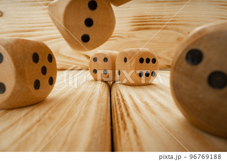 Wooden dice tossed on wooden background close up Wooden dice tossed on wooden background close up 96769188