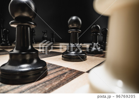 Chess board with figures on dark background 96769205