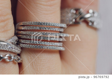 close up of boho styled woman hands with silver jewelry. close up of boho styled woman hands with silver jewelry. 96769792