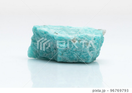 Natural amazonite gemstone isolated on white background. A bluish-green crystal on a white background. A variety of potassium feldspar microcline Natural amazonite gemstone isolated on white background. A bluish-green crystal on a white background. A variety of potassium feldspar microcline 96769793