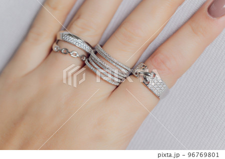 close up of boho styled woman hands with silver jewelry. 96769801