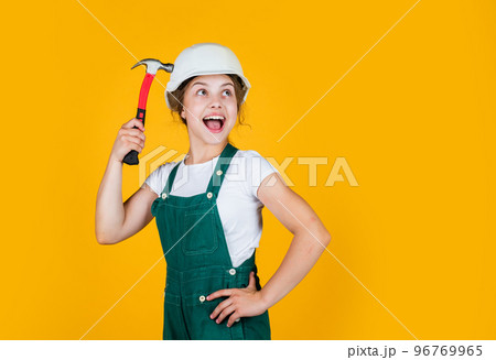 she can fix anything. future engineer. happy kid use hammer repairing tool. building construction site. child architect worker. labor day concept. childhood development. teenager girl assistant 96769965