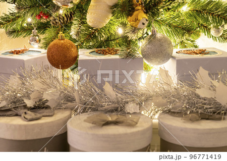 beautiful Christmas gifts under the tree, tinsel around gifts square beautiful Christmas gifts under the tree, tinsel around gifts square 96771419
