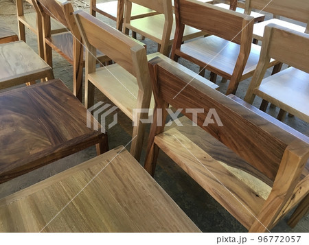 A chair modern wood frame with wooden, sunlight coming through the window illuminating the chair A chair modern wood frame with wooden, sunlight coming through the window illuminating the chair 96772057