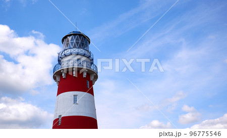 Lighthouse against the background of the blue sky. Lighthouse on a clear sunny day Lighthouse against the background of the blue sky. Lighthouse on a clear sunny day 96775546