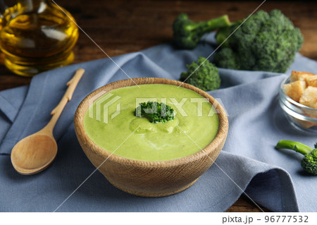 Delicious broccoli cream soup served on wooden table Delicious broccoli cream soup served on wooden table 96777532